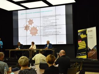 Spotkanie dotyczące współpracy KGHM i UJW, z prezentacją na dużym ekranie.