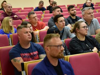 Widok kilku rzędów słuchaczy wykładu o ratownictwie w auli.