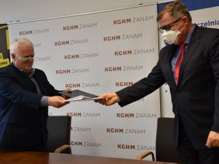 Sygnatariusze wymieniają się teczkami z dokumentami.